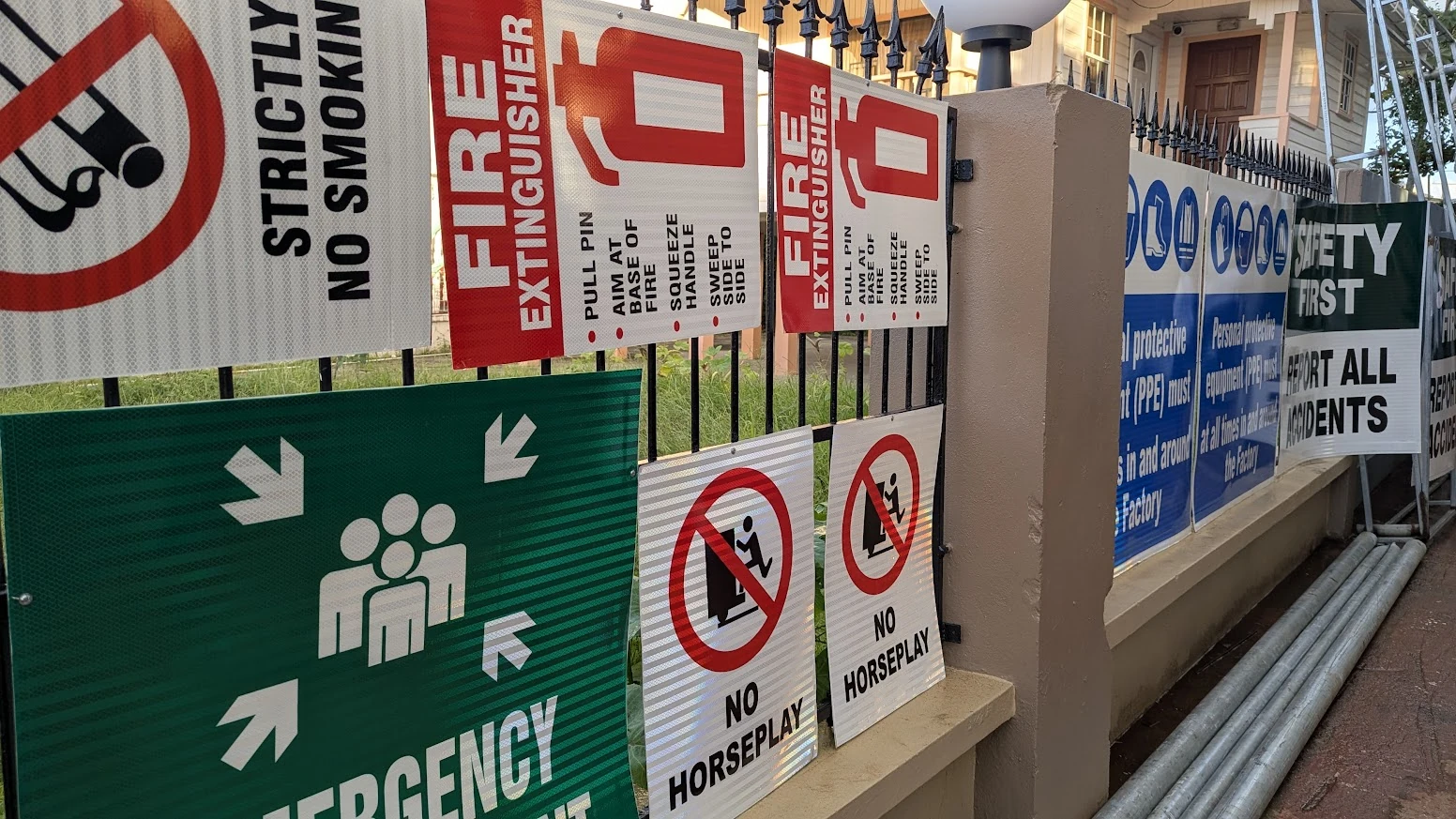 Reflective worksite safety signs including fire extinguisher and assembly-point notices